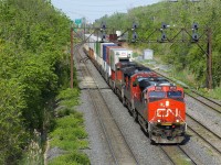 CN 120 has CN 2942, CN 2100 & CN 2648 up front and CN 8853 as mid-train DPU as it leaves Taschereau Yard. This 640-axle long intermodal train originated in Toronto and will terminate in Halifax.