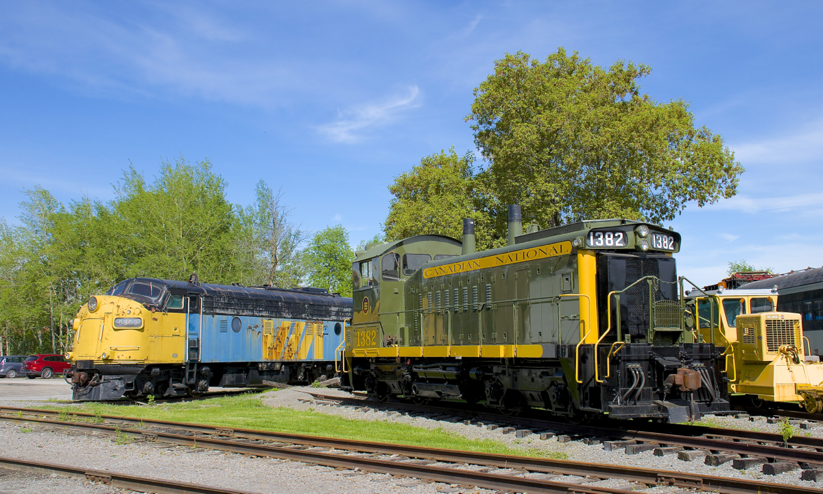 VIA 6309 and CN 1382 are seen at Exporail on a sunny afternoon.
