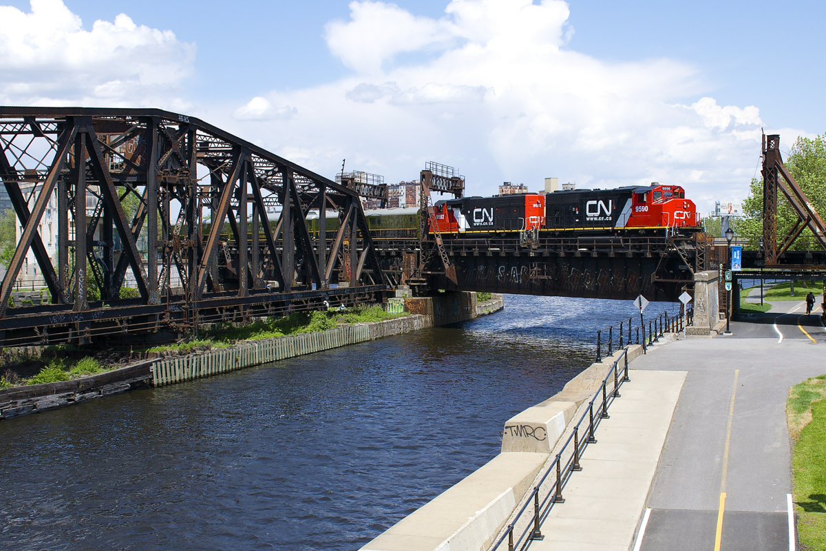 As part of Canada's 150th anniversary, CN ran a special Confederation train from Montreal to Ottawa this afternoon. The Confederation Players (a theatre troupe from Charlottetown)went to in Ottawa on this train, as well as numerous politicians, including the mayor of Montreal and Charlottetown. Power is a great looking pair of GP40-2L(W)'s (CN 9590 & CN 9592) and behind are the CN passenger cars Fraser Spirit, Champlain, Tawaw and the Sandford Fleming. Here the train is seen crossing the Lachine Canal a few minutes after leaving Central Station in Montreal.