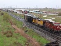 'When it rains, it pours" It's aways the case, if the weather is bad then all the interesting power will show up. Even though it was pouring I didn't want to give up the opportunity to photograph one of the only two D&H GP38s left in their old owners paint. Five minutes after showing up, a westbound with a UP SD70ace trailing arrived, and stopped to drop off a bad order car. Ten minutes later train 147 arrived and had to wait for the other trains power to return to its train before it could cross over to the south track, clearing the north track for a pair of  eastbound clearing Guelph Junction. Not bad for a railroad that almost always seems to run most trains under the cover of darkness. 