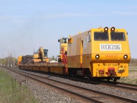 Canadian Pacific has begun spring cleaning along the Galt subdivision. here we see the Herzog train heading west out of the dip in Hornby after crossing over from the north track to the south. Lead unit #187 is a custom built unit that appears to be built on a GP9 frame (I would love to know the history), the rest of the train is converted container flats upgraded to allow front end loaders to travel the length of the train. The train has been busy collecting old ties that have been discarded along the roadbed for a number of years.