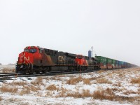 A couple of ES44AC's lead a eastbound intermodal train through Ryley on a snowy April day.