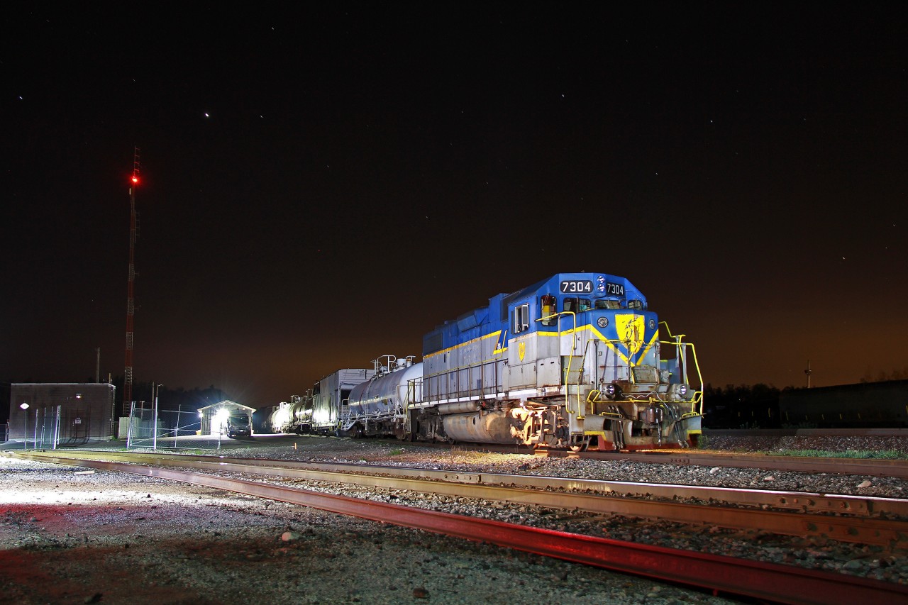 This shot may be beating a dead horse, but shooting D&H 7304 leading the weed train in Niagara in the morning was not an option. Thanks to the help of a couple others and some tossing around of my flashlight, this managed to turn out. One can definitely appreciate that CP decided to park the train out in the open where shots were possible. Indeed, 7304 would head to Welland, Niagara Falls and Port Maitland after sunrise. I still cringe at the thought of not getting a shot of it in Niagara Falls, though you can't be everywhere, and drone shots are prohibited anywhere near the city. 

For what it's worth, this opportunity at least almost makes up for it. 7304 is now on the MacTier Sub doing its rounds. Having both D&H 7303 and 7304 in Southern Ontario in the past month has been quite welcome. Being the last two units in D&H paint, who knows how much longer it'll be before before they get a coat of CP red.