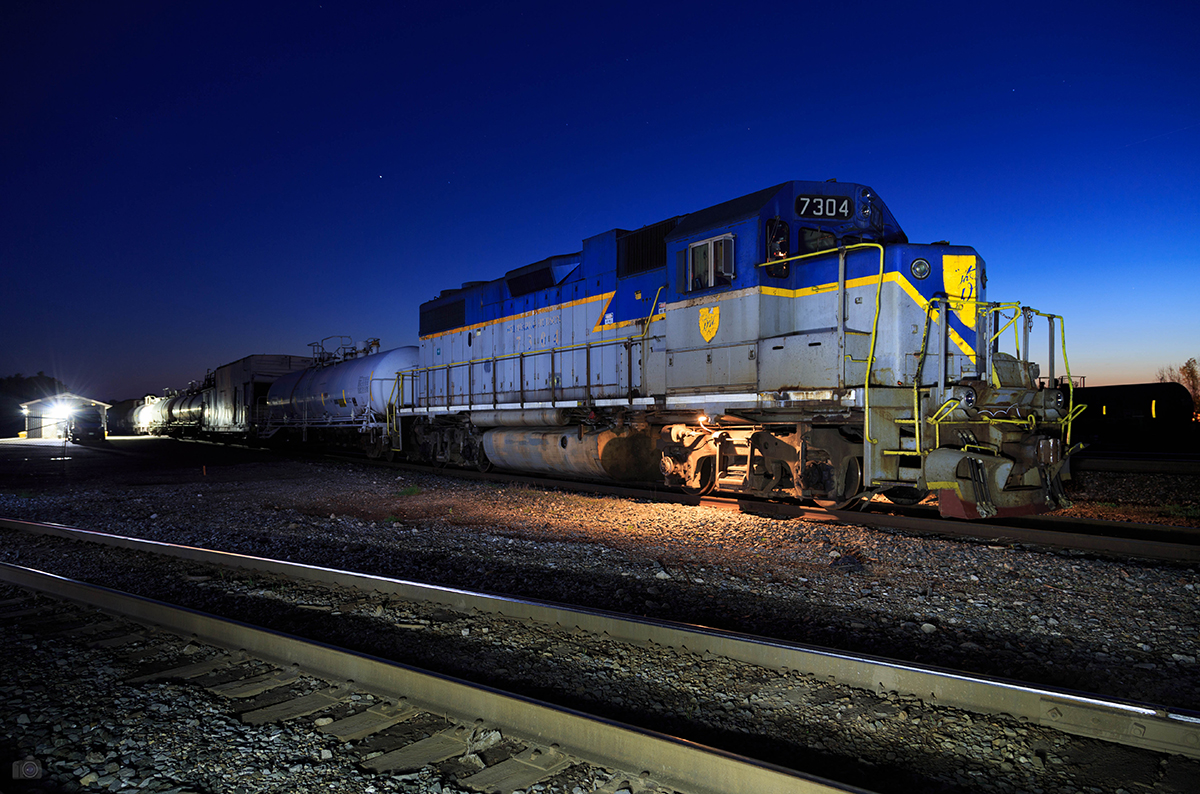 From twilight to dusk and a bit of light painting, D&H 7304 and its 8 car weed spraying train is all tied for the night at Guelph Jct.