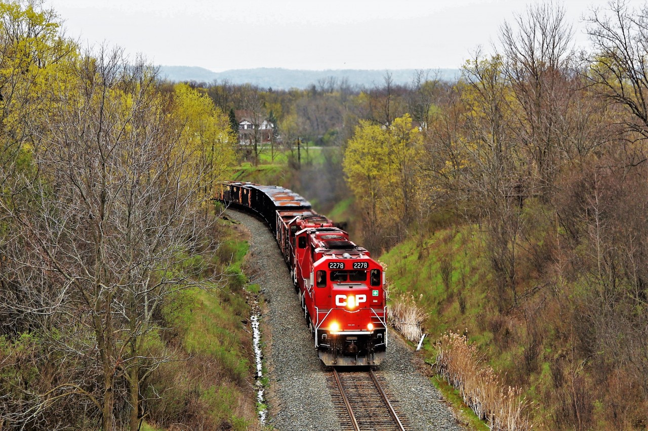 This was the return trip headed north from Hamilton of the management train with an assorted trio of CP power in (GP20C-ECO) CP 2278 leading, with (SD60M) CP 6258 and (SD40-2) CP 6017 for assistance, after they had picked up loaded ballast cars and several gondolas of used ties and head under the Newman Road overpass