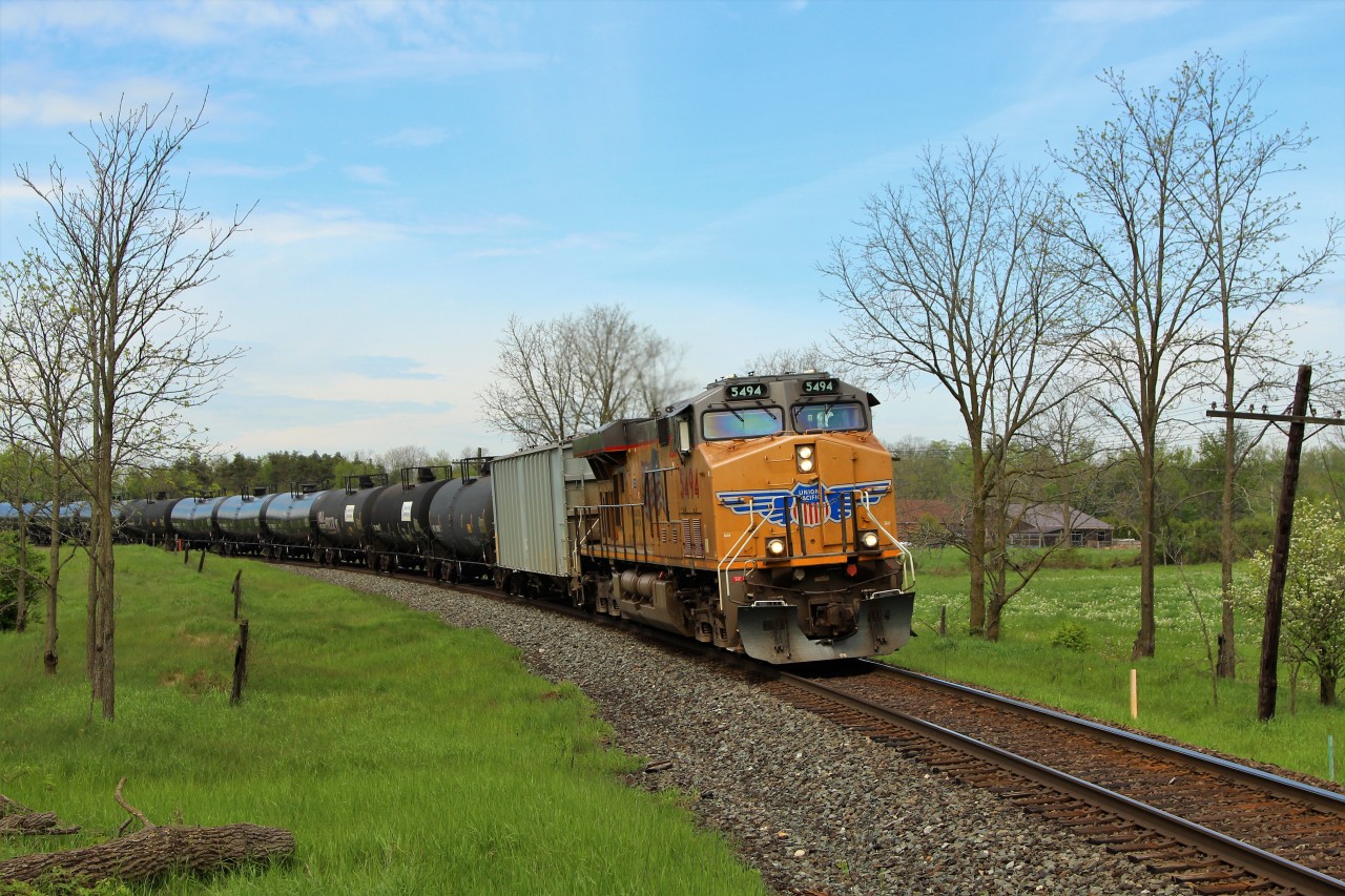 UP 5494 leads a tanker train eastbound on the Galt sub with another Union Pacific in UP 5458 as tail end DPU cleared to Guelph Junction.