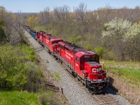 CP 5023 charges up the grade out of Hamilton with a trio of EMDs for power and a 24-car management train.