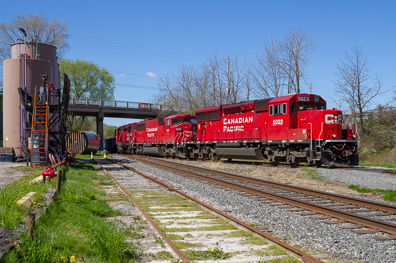 On a sunny May morning, an eclectic trio of EMDs notch up as they swing around the Aberdeen wye with a 24-car management train in tow.