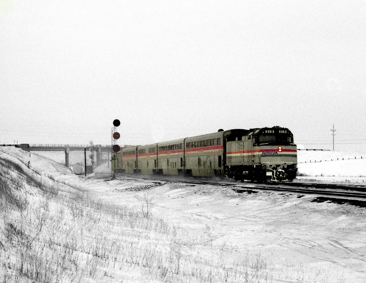 In 1985 Via Rail leased an Amtrak train set to test HEP power trains. The set was used on the Winnipeg Edmonton Panorama and on a very cold January day the eastbound passes underneath Highway 83 at Miniota between Melville and Rivers
