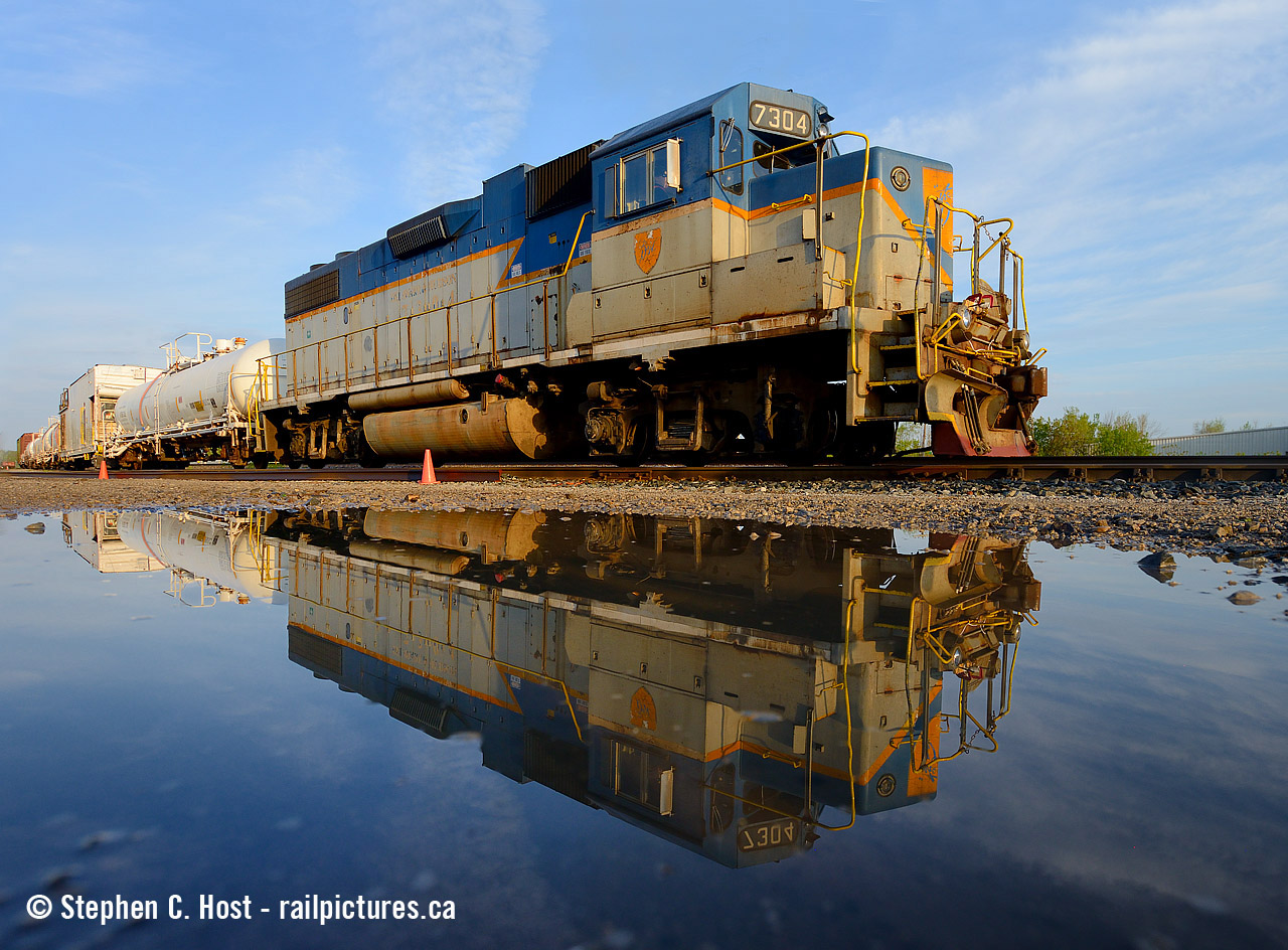 And in my continuing series of spring puddle shots - here's 7304 reflected in a small puddle just prior to getting under way  at 0654 in the morning. Snake, did you buy Wal-Mart stock yet? Or those water companies... BTW this is what happens when our Mr. Mooney, The D&H's biggest fan, goes away on vacation. Thanks Arnold !! :)