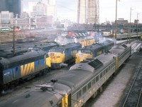 A Doug Lawson photo.A candidate for the Time Machine.Del Rosamond's 1961 photo - http://www.railpictures.ca/?attachment_id=17034In May 1961, Del Rosamond stood on the Spadina Ave bridge and captured a bevy of GMD1's, sprinkled with cab units, switchers and geeps. Very few were carrying the new paint scheme introduced in 1960.In December 1982, Doug Lawson stood in nearly the same position and captured a different look, although the end goal is the same - passenger service. Here we can see a matched pair of Ontario Northland FP7's, along with VIA F9's and FPA4's, plus a handful of RDC's. There are other things of course - the CN Tower is now in place, along with the elevated walkway for access. John Street interlocking is fully visible in both images, as opposed to today when you'd need to get on your knees to find it beneath the commercial growth. So which do you prefer ??