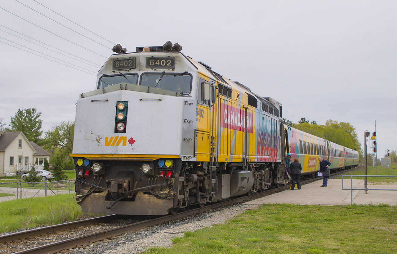 " When it rains, all the interesting power comes out.. " PART TWO ...yes, it still seems to be the case. I had seen the new Canada 150 wraps already on the P42's, but had yet to capture my first photos of it on the F40's. To my delight, on a day that spawned the beginning of a lousy first week of weather for May...VIA 6402 pulls into it's station stop at Glencoe. The lone passenger waiting to board his train must have thought "this guy is crazy!", as I couldn't contain my excitement as train 76 rolled into Glencoe. Interesting too - one passenger arriving, one about to board and depart. Also of note - had I relocated 5 minutes down the line towards Newbury, I probably would have gotten a great passing shot of VIA train 76 to London, and 73 to Windsor. Maybe next time...