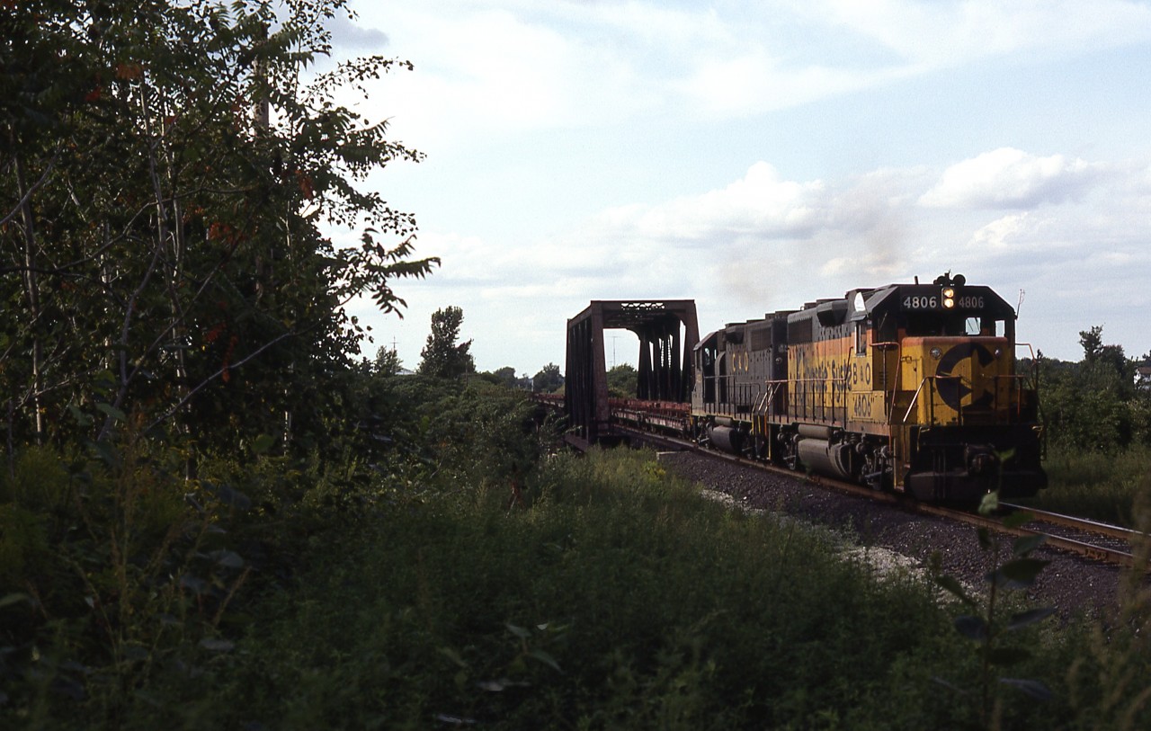 Today it is CPRail's turn to be operating a Nanticoke Steel train. Prior to the "Cainsville Fill" landslide, this train operated from Aberdeen Yard in Hamilton, west to Waterford, then onto the former LE&N right of way to Simcoe, then on to the CN Cayuga Sub to Garnet, then south again to Nanticoke. In this timeframe, CP is using leased B&O and C&O GP38's, either in pairs or trios, to handle the train. So here we have B&O 4806 ( with C&O 4823) pulling a CPRail train, on former Lake Erie & Northern trackage, and using the steel truss bridge to cross overhead of Conrail, former NYC, Canada Division mainline ! (and technically the last few cars may still be on the former TH&B Waterford Sub).