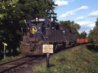 Another scene involving CP's Nanticoke Steel train, this time in West Brantford. Leased GP38's 4807-4809 are sneaking their way out of the tree cover at Gilkison Street, with the remainder of the train still on the Grand River bridge and beyond. These unprotected crossings were not used to daytime moves until this train began to operate on a semi-regular basis. Ironically this group of engines would end up being the 'domesticated' power for use on CSX Canadian District after 1988.