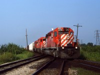 A westbound with 5774 and one of the repainted QNSL’s, 5407 (plus another CP) in the trailing position, hammers across the CN Chatham Sub on it’s way to Windsor. The sweet evening light was perfect for westbound moves on both railways, at this location.