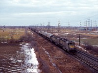 A Mike McIlwaine photo. A threesome of QNSL SD40's brings a westbound under Lauzon Road on approach to Windsor in early 1984. CP purchased QNSL 204-218 and eventually repainted/renumbered them to 5400-5414. Instead of hauling taconite pellets in Labrador, they spent the last half of their lives on higher speed merchandise and intermodal trains. 