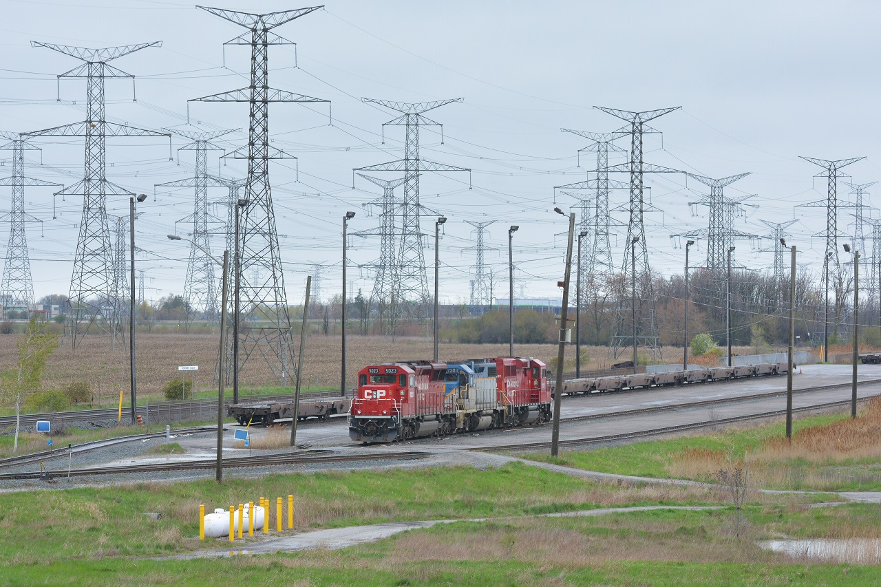 Awaiting the evening departure, CP 132's power rests in the rain at Hornby East with DH 7303 sandwiched in the center