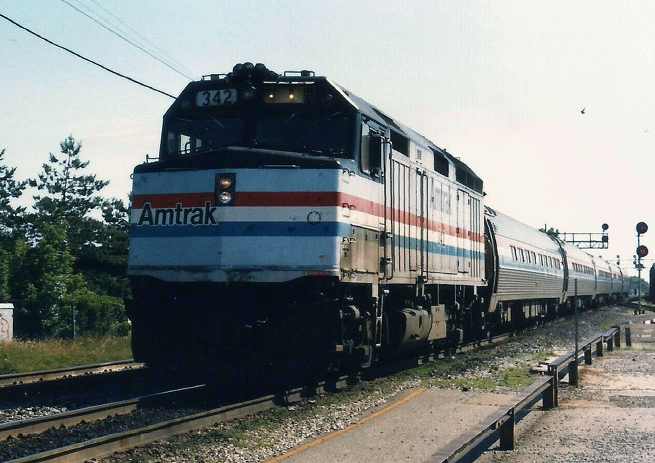 Amtrak unit #342 leads a 5 car train at a stop at Burlington West to pick up passengers.