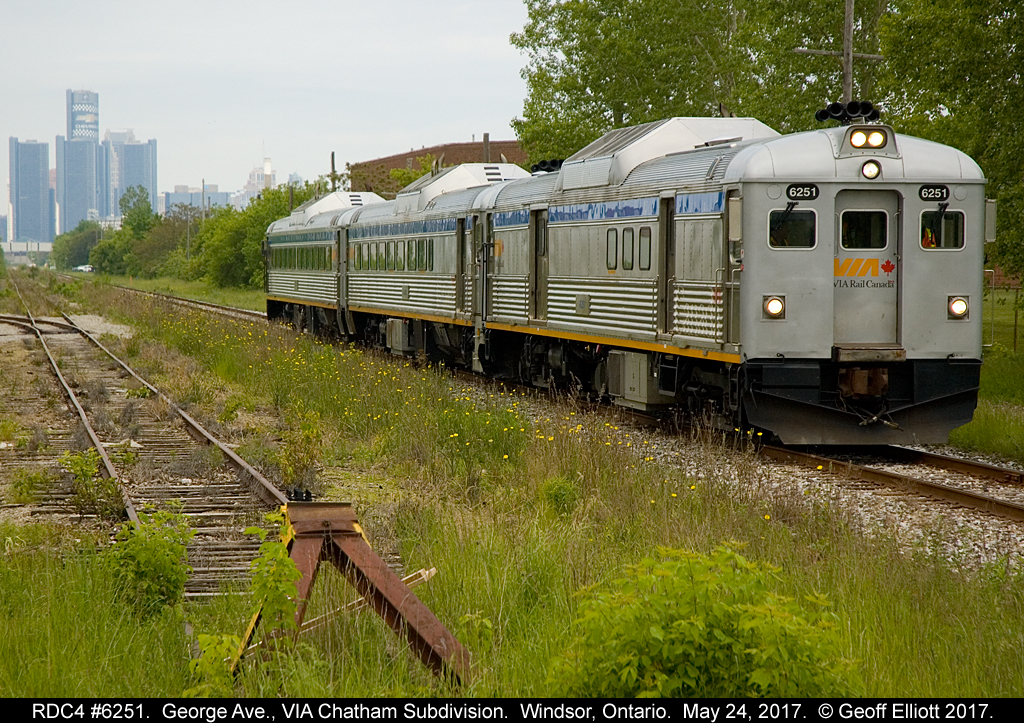 Three of VIA's rebuilt RDC's, led by RDC4 #6251, roll eastbound at George Ave. in Windsor, Ontario on May 24, 2017. In the background GM's World Headquarters looms in Detroit as a reminder that this is a modern photo and not something take in the 60's when RDC's were still relatively new.  As part of the Memorial Cup Tournament hosted in Windsor this year, VIA helped promote the event by shuttling school students to/from the Windsor Station to the WFCU center to enjoy a display explaining the history and meaning behind the Memorial Cup as well as teaching the children about safety around the railroads. Very impressive site seeing a trio like this again.