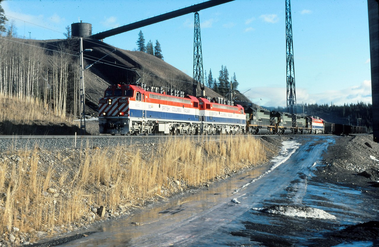 On a sunny morning I was out and about, stopped by the Teck loadout. It was hard to believe it was January with the lack of snow on the ground. Whole different story snow wise "up the mountain". While there I was surprised with this south bound loaded coal train and the collection of locomotives. The two leading electric locos were likely working, but not sure about the diesels, the trailing electric locomotive would be "dead in tow". Diesels could MU trail and operate to the electric locomotives. If diesels were leading, any trailing electric would be dead with pantographs down.
