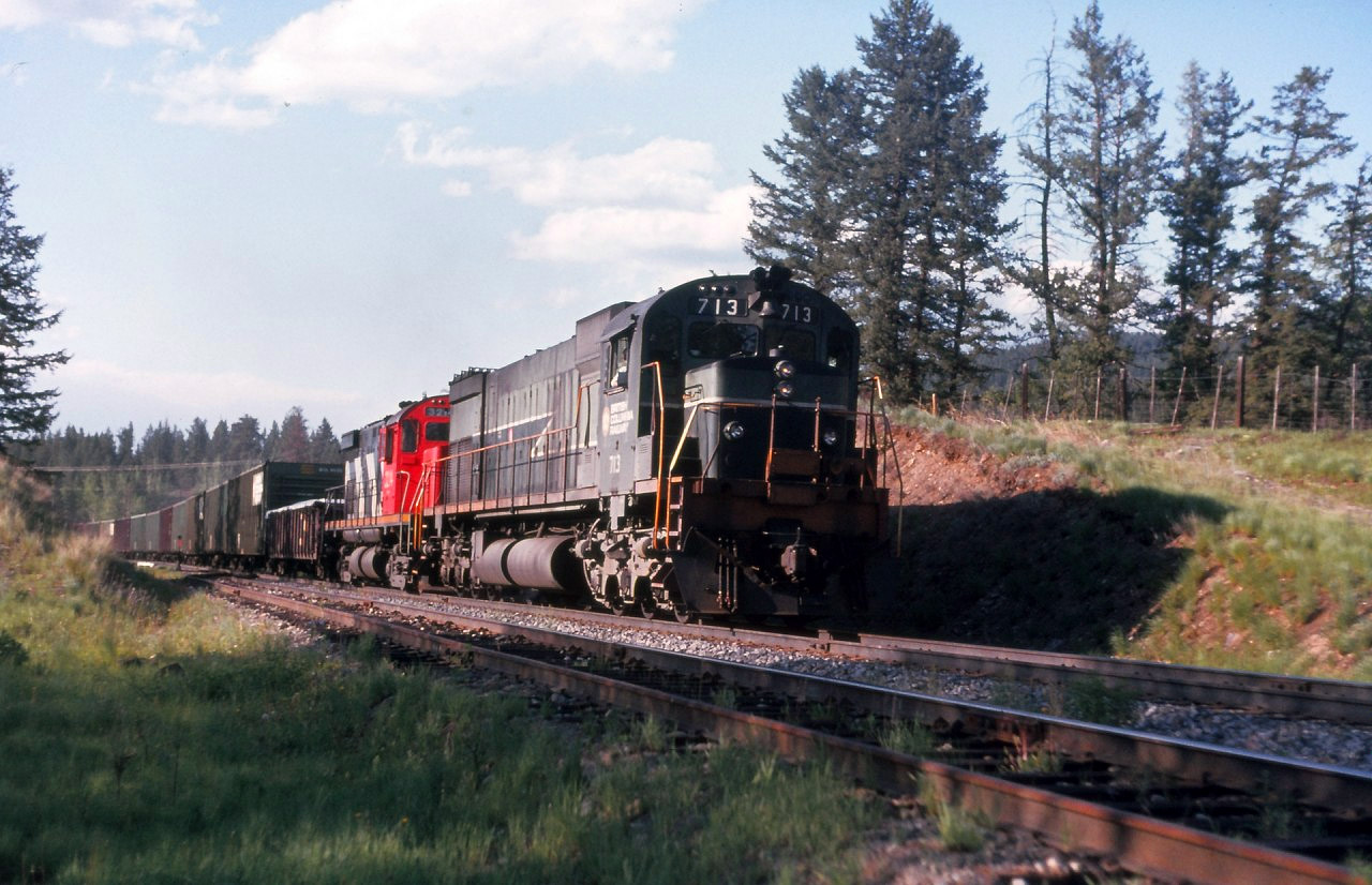 Meet at Mackin. No doubt I was with the train in the siding waiting for this southbound train. Judging by the afternoon light this would be #32 "PV" symbol train from Prince George and only a few more miles left to Williams Lake. Unfortunately the headlights were dimmed, perhaps with all the headlights on bright would have added to the image. Also a CN leased unit trailing as well as remotes cut in way back in the train. All ancient history now.