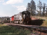 Meet at Mackin. No doubt I was with the train in the siding waiting for this southbound train. Judging by the afternoon light this would be #32 "PV" symbol train from Prince George and only a few more miles left to Williams Lake. Unfortunately the headlights were dimmed, perhaps with all the headlights on bright would have added to the image. Also a CN leased unit trailing as well as remotes cut in way back in the train. All ancient history now.