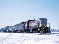 As if CP didn't have their own problems dealing with a locomotive shortage and leased engines from several sources; Penn Central couldn't keep their end of the bargain when it came to powering the Buffalo/Toronto service. So on this bitter February morning, somewhere between Brimley and McCowan, I managed to get close enough to the right of way as CP sent 7064 out to Leaside to rescue the ailing KINNEAR. 1 or 2 of the classic PC engines had finally died and the tonnage was too great to keep the train moving. So F7's 1747 and 1729, with GP9B 3829 are getting a helping hand from MLW's finest in order to land the train in the Receiving bowl. Note the piggyback business which was hit and miss on this train starting after mid 1971 ( if I recall).
Original slide taken with a Kodak INSTAMATIC.