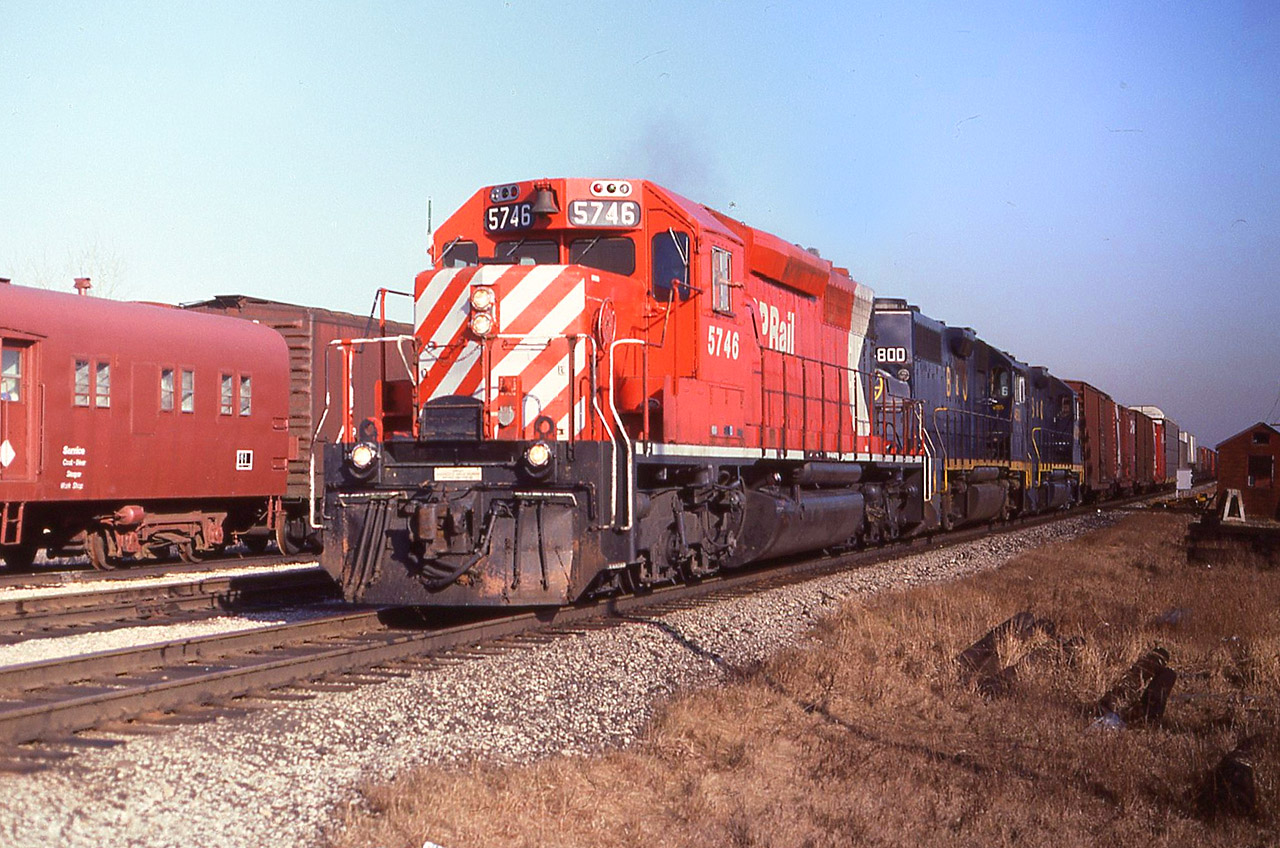 In the period 1982-1984 CP again went to B&O ( by now, officially Chessie System) for leased power.
A westbound at Belle River, Ontario shows clean 5746 with the white frame stripe leading B&O GP38’s 4800-4816 past the service equipment on Mar 22/84. In a couple of years those GP38's would become the domestic power on CSX lines within Ontario, so instead of watching them go by, I'd be operating them.