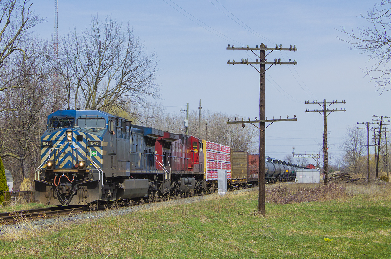 In a failed attempt at a time machine shot  (of Bruce Mercer's photo)  of the CP in action, I was able to capture CEFX 1045 in the lead this day entering Chatham at Princess Street. Notable changes - the tower at the interchange with the C&O is long gone, as is the diamond itself. Also gone too is the train order signal that is shown back in the distance on Bruce's photo. Only true way of marking such a photo is the telephone poles that still remain. No re-attempt here - "No Trespassing" signs have been posted by the CP as well as curious onlookers from the tenants of the house (out of photo) to the right of me.
