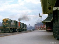 Canadian National RS18's 3864 and 3090 lead a sister unit on a westbound freight past Brantford Station, at Mile 23 of CN's Dundas Sub in May of 1965.