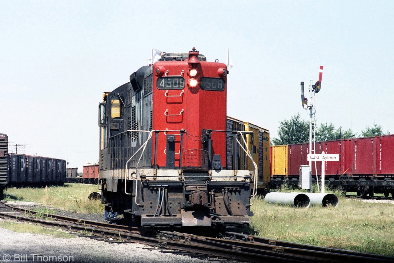 CN GP9 4508 is in charge of this wayfreight job, switching cars in the yard at Aylmer in the Summer of 1981.