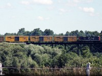 Further to the photo of <a href=http://www.railpictures.ca/?attachment_id=29747><b>CN 4508</b></a> switching the yard at Alymer, the wayfreight is shown here before arrival in town, crossing a bridge on the line to the west. In tow behind the GP9 are then-modern yellow Railbox boxcars, one slightly fresher/newer than the others.