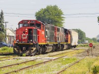 <b> JACKPOT! </b> Having moved to Chatham, I have to say I miss seeing the CN a bit. Not a lot of opportunities arise that I can get photos of CN  in Chatham. However, Saturday was a good day for railroading. After being up early in the morning and seeing the 6:30 VIA departure from the Chatham station, I had seen 3 more trains. However, those were all missed opportunities...but then came Blenheim. And, there they were. The red nose of CN 4785, with sister 4784 in tow along with the lone grain hopper being taken back to Chatham. I had just enough time to drive quickly into the Thompson's parking lot, putting the car into park and getting this photo to capture my 5th train of the morning. Knowing about the lack of traffic on the once busy C&O trackage through Blenheim, this was special.