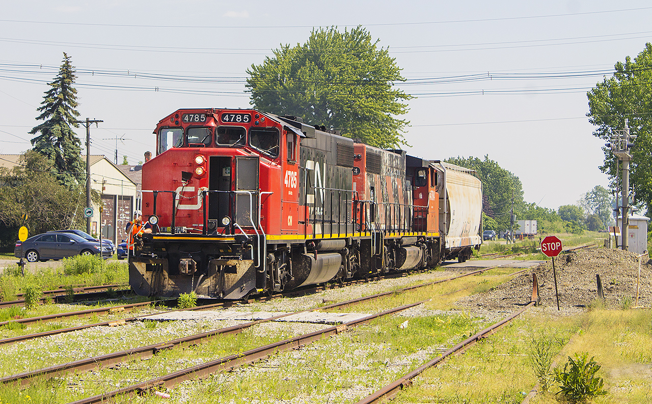 JACKPOT!  Having moved to Chatham, I have to say I miss seeing the CN a bit. Not a lot of opportunities arise that I can get photos of CN  in Chatham. However, Saturday was a good day for railroading. After being up early in the morning and seeing the 6:30 VIA departure from the Chatham station, I had seen 3 more trains. However, those were all missed opportunities...but then came Blenheim. And, there they were. The red nose of CN 4785, with sister 4784 in tow along with the lone grain hopper being taken back to Chatham. I had just enough time to drive quickly into the Thompson's parking lot, putting the car into park and getting this photo to capture my 5th train of the morning. Knowing about the lack of traffic on the once busy C&O trackage through Blenheim, this was special.
