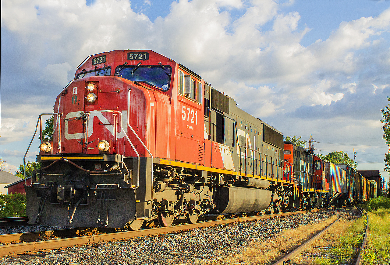 After getting a tip that this train was slowly moving through Chatham, I raced with anticipation of getting some decent photos of the CN within town limits. Having driven around for about 10 minutes, I finally caught the headlights of 5721 in the distance while crossing Sass Road. I pulled into the (unknown) factory parking lot, and took a position on the now abandoned siding. My goal was to photograph the train coming off of the MacGregor Creek bridge, with the signals showing on either side of the train while it coasted along the eastbound main.. However, without knowing until the train came off the bridge, they took the former westbound main! With CN 5721 leading and 4071 trailing as the second unit, this train quite literally pulled a 'switch' on this photographer! Sometimes you just have to roll with the punches.