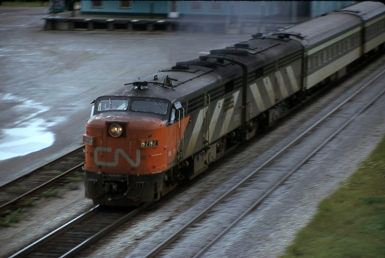 I'm up on the Waterdown Rd bridge and with a telephoto lens on, (this is the old film days) I realize I cannot get enough light for the shot. So I make an effort at panning.  Not bad. In the background is the base of the old Aldershot Cold Storage building, now a part of history. Eastbound 6782,(retired by 1989) shot well after the dinner hour.