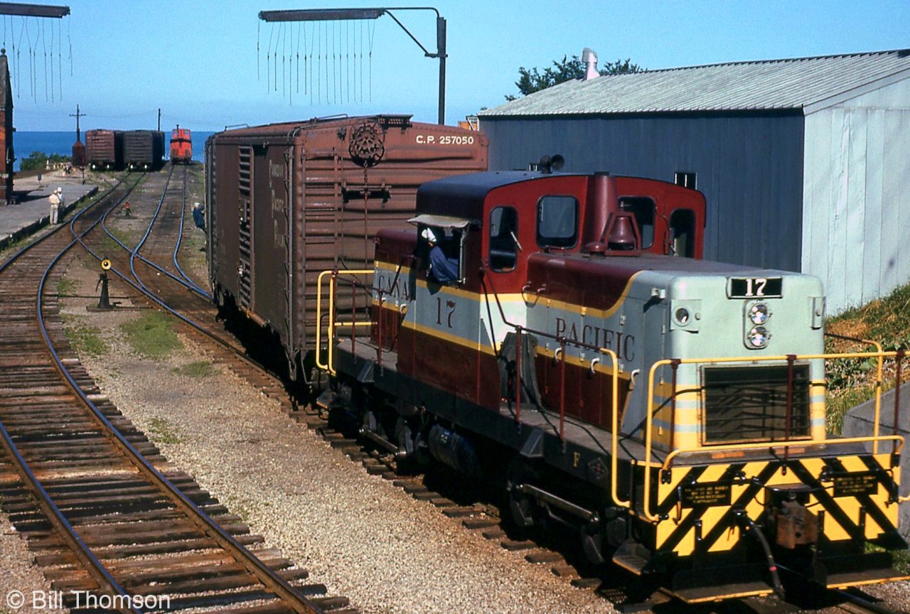 Another view of CP's resident CLC DTC switcher assigned to Goderich: unit 17 is shown switching car in the yard, with the engineer leaning out of the cab window as a crewmember rides one of the 40' boxcars. Note the tell-tales visible above the first car, and the station on the far left. Lake Huron is visible in the background, beyond the caboose.17 posed in front of the station: http://www.railpictures.ca/?attachment_id=2956018 at Goderich by the station platform: http://www.railpictures.ca/?attachment_id=29474