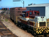 Another view of CP's resident CLC DTC switcher assigned to Goderich: unit 17 is shown switching car in the yard, with the engineer leaning out of the cab window as a crewmember rides one of the 40' boxcars. Note the tell-tales visible above the first car, and the station on the far left. Lake Huron is visible in the background, beyond the caboose.<br><br>17 posed in front of the station: <a href=http://www.railpictures.ca/?attachment_id=29560><b>http://www.railpictures.ca/?attachment_id=29560</b></a><br>18 at Goderich by the station platform: <a href=http://www.railpictures.ca/?attachment_id=29474><b>http://www.railpictures.ca/?attachment_id=29474</b></a>