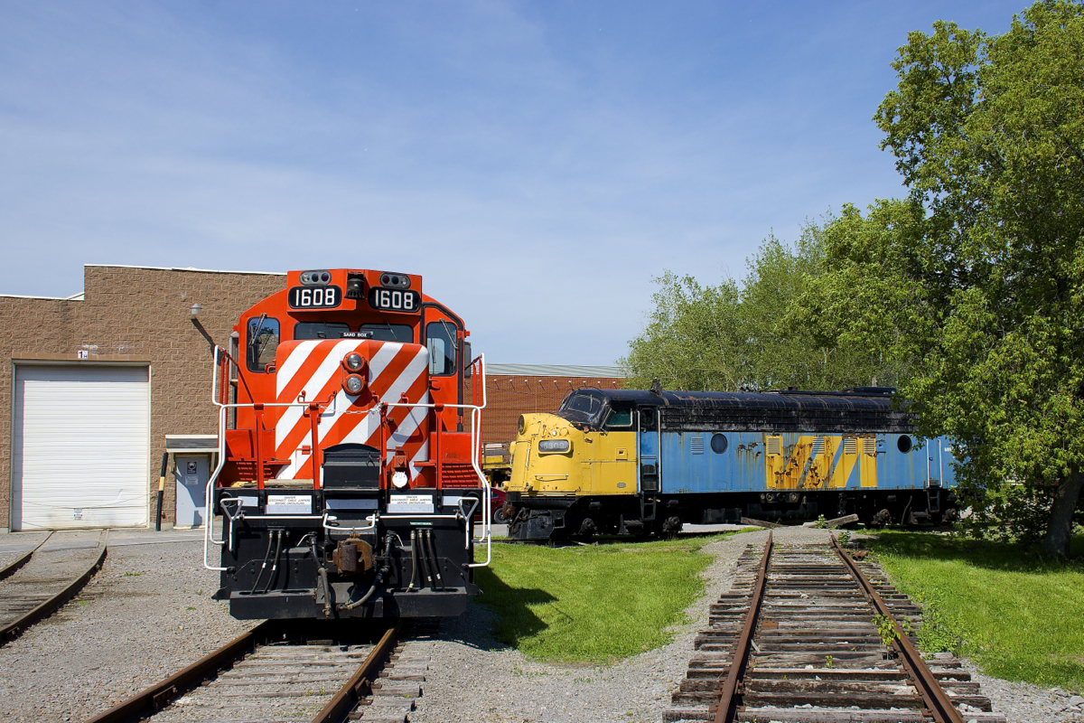 GP9 CP 1608 (built in 1956 as CP 8611) and FP9 VIA 6309 (built in 1957 as CN 6528) are seen outside Exporail's two-track shop a sunny Sunday afternoon.