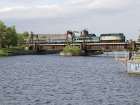 VIA 22 is led by VIA 6452 as it crosses the Lachine Canal with a mixed consist.