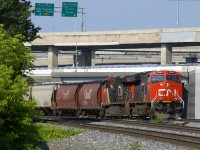 CN 878 with  & CN 2853 for power is parked on CN's Montreal Sub in the morning, as the Port of Montreal would not be ready to take it for quite some time. Up above is the Turcot interchange, which will soon be replaced by a newer set of ramps and exits. CN 878 originated in Canora, SK. Grain trains east of Thunder Bay are quite rare in the summer, but a number of CN 878's have run to Montreal during the past couple of weeks.