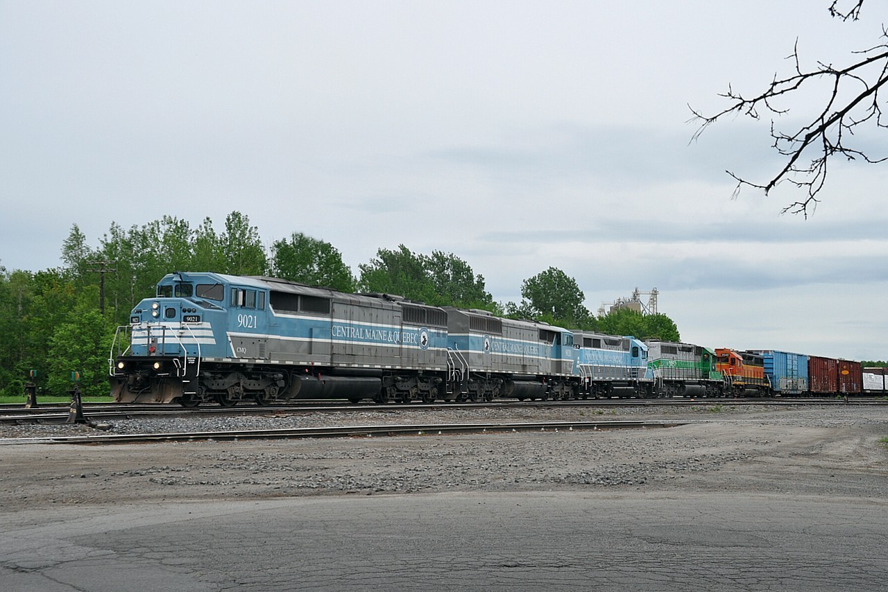 On a recent visit to the principal Central Maine & Quebec yard at Farnham, I thought I was going to get skunked. Nothing there but a few rail cars and a whole slew of 'no trespassing' signs; especially around the former CP Office and Station which looked gutted. Hopefully restoration is in order. All of a sudden the signals activated. Phew!!!  And in backed a 5 unit freight. Now, THAT was better. So this was the catch, CMQ 9021, 9020, 3816, 3057 and LTEX 2540. The first two units x-CP "barns" and the last unit still in BNSF colours. The 3057 I remember seeing numerous times as FURX. The 3816? No idea on it. Anyone?