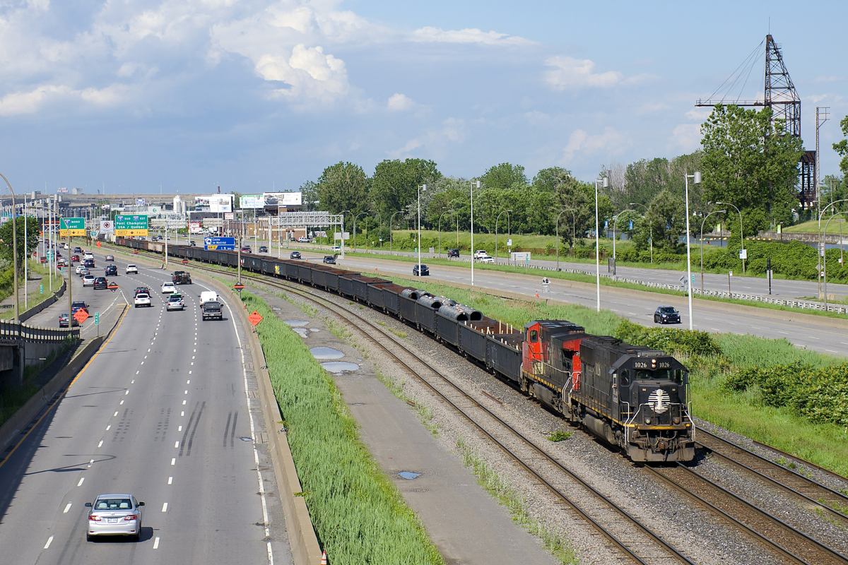 CN X321 has IC 1026 & CN 2509 for power as it slowly heads west on CN's Montreal Sub; carmen will inspect it a bit further west at Ballantyne. At the head end is a very long string of gons, a common sight on this train which runs on as needed basis from Southwark Yard in St-Lambert to MacMillan yard in Toronto. The power had come into the Montreal area earlier this morning on CN 186.