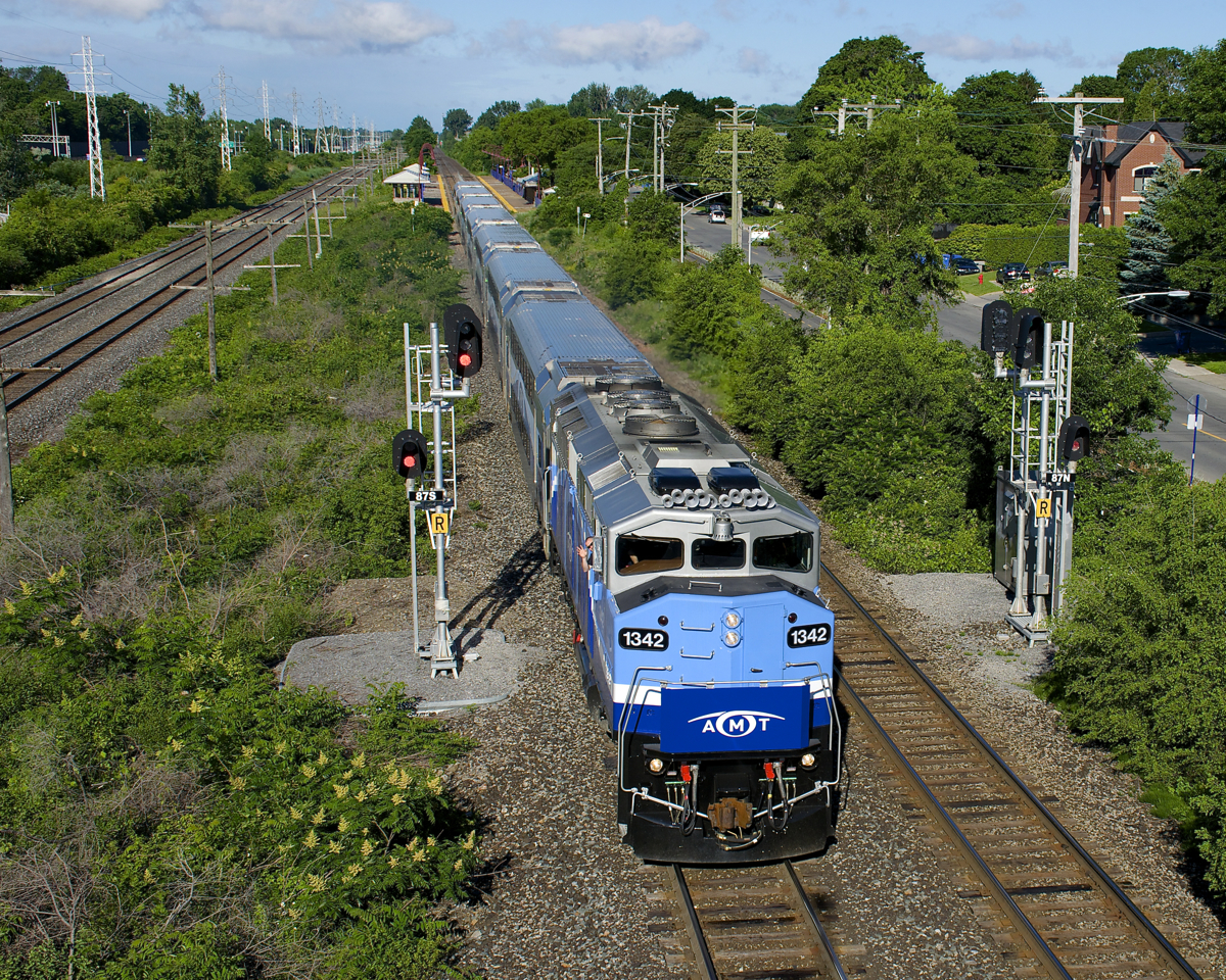 It's a sad week for many CN and CP employees in the Montreal area this week, as the jobs they had running AMT commuter trains will be taken over by Bombardier starting next Monday. Here AMT 16 with ex-GO Transit F59PH AMT 1342 accelerates away from its stop at Cedar Park Station. The engineer is a CP employee and a friend of mine and he waves out the window as his train approaches the St-Jean overpass.