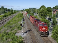 <b>What a difference a year makes.</b> A bit over a year ago I <a href=http://www.railpictures.ca/?attachment_id=24932>shot CP 118</a> splitting this set of signals on CP's Vaudreuil Sub in Pointe-Claire, and the tracks were surrounded by a wall of trees. CP (and/or CN, whose Kingston Sub is just at left) did a lot of brush clearing this past spring, and it's a very different scene as a 452-axle CP 112 passes with CP 8937 up front and CP 9352 mid-train this morning.