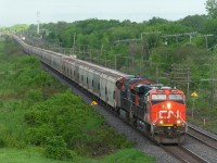 With 205 loaded potash cars, CN B730 looks like a slithering snake as it heads west through Beaconsfield early in the morning. Power is 4 AC units with CN 2948 & CN 3065 and CN 2876 & CN 2887 mid-train.