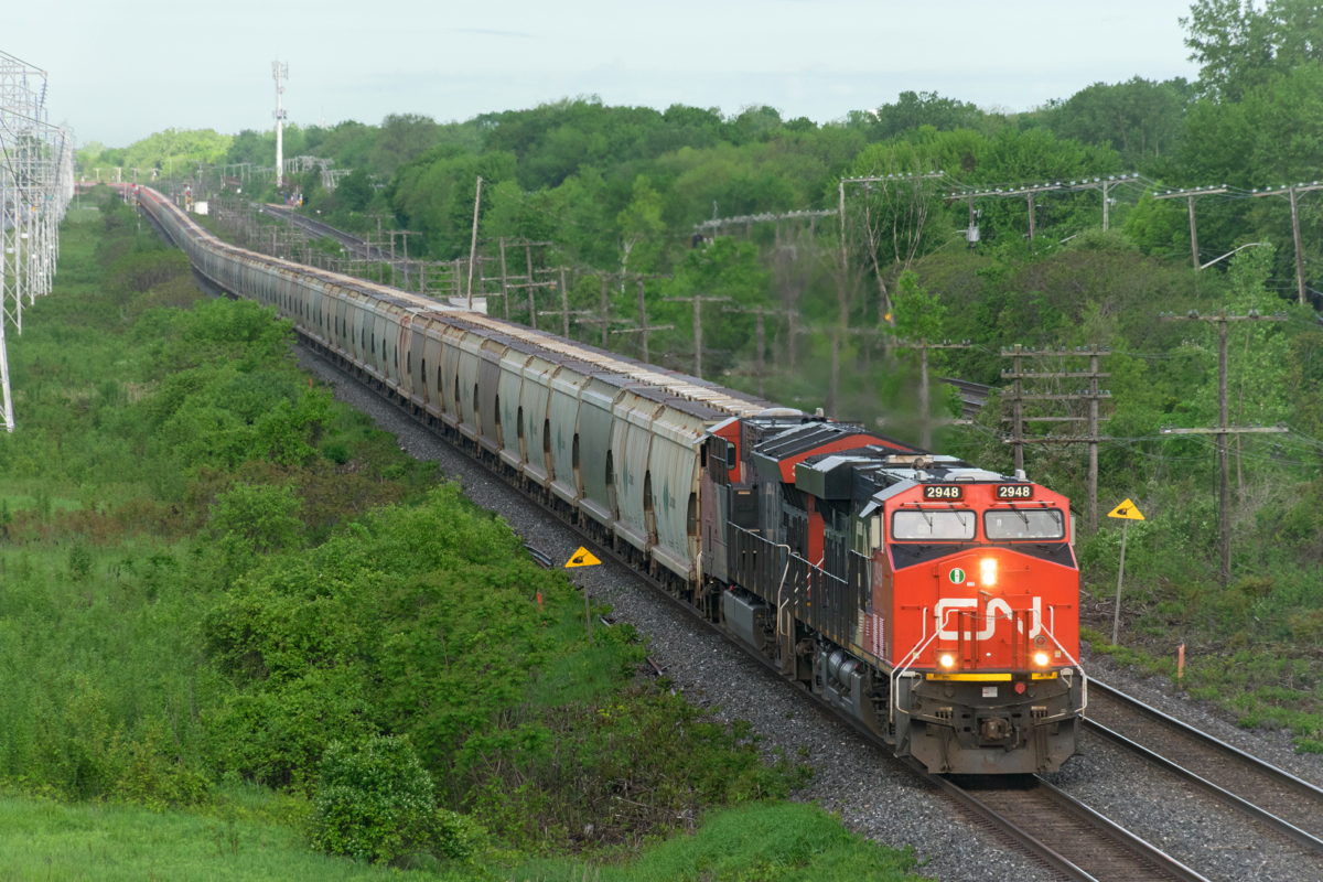 With 205 loaded potash cars, CN B730 looks like a slithering snake as it heads west through Beaconsfield early in the morning. Power is 4 AC units with CN 2948 & CN 3065 and CN 2876 & CN 2887 mid-train.