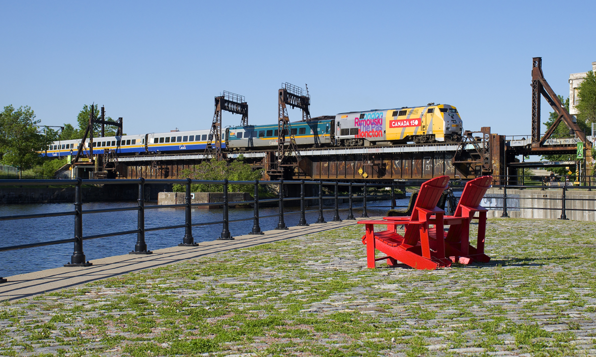 VIA 22 from Fallowfield is just about into Central Station in Montreal as it crosses the Lachine Canal with wrapped VIA 907 leading. Behind the rebuilt and repainted VIA 1 LCR car are three unrebuilt LRC cars, still in their original paint scheme.