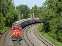CN B730 has the usual complement of 4 AC units (CN 2841 & CN 2850 up front and DPU's CN 2958 & CN 2966) and 205 loaded potash cars as it very slowly rounds a curve as it approaches Turcot West for a crew change.