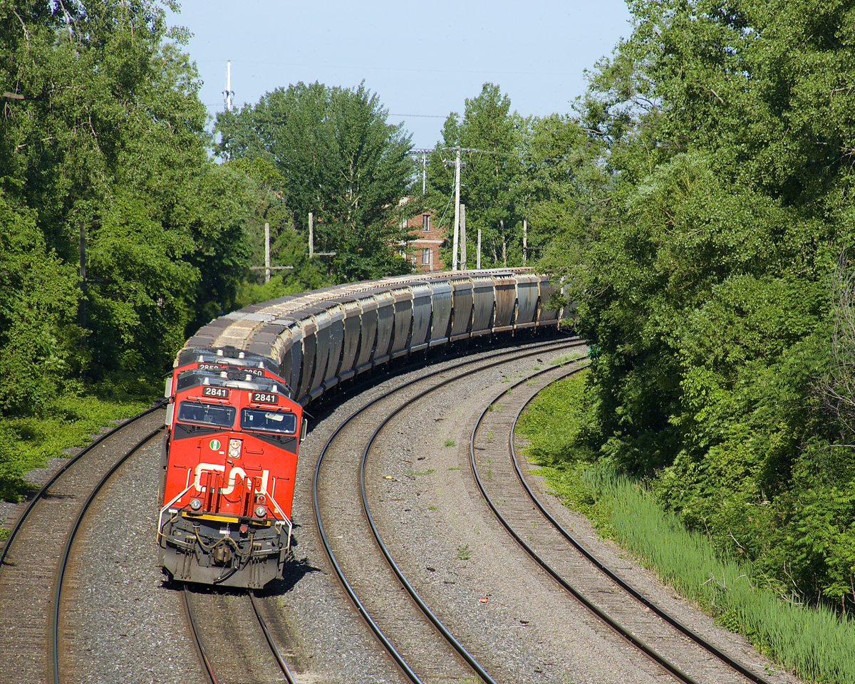 CN B730 has the usual complement of 4 AC units (CN 2841 & CN 2850 up front and DPU's CN 2958 & CN 2966) and 205 loaded potash cars as it very slowly rounds a curve as it approaches Turcot West for a crew change.